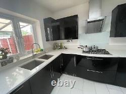 Modern luxury Black Unit & Granite white worktop kitchen. Appliances included
