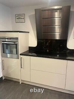 Used glossy cream kitchen, kitchen units with granite worktop and appliances